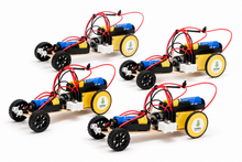 Load image into Gallery viewer, Four small electric wheeled robots arranged in a 2x2 grid on a white background. Each robot has a black chassis, yellow wheels with white logos, blue battery packs, and red wiring.
