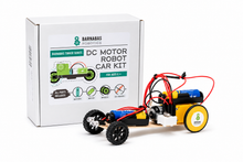 Load image into Gallery viewer, Barnabas Robotics DC Motor Robot Car Kit shown with its white retail box on a clean white background. The kit includes a small wheeled robot with black wheels, a blue battery, yellow and black chassis, and red wiring.
